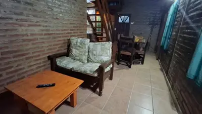 a living room with a chair and a coffee table at Los Teros in Tanti