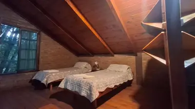 a bedroom with two beds in a attic at Los Teros in Tanti