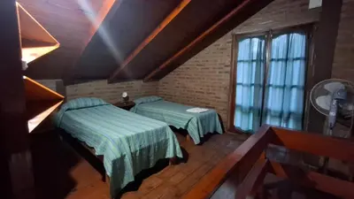 a room with two beds and a window at Los Teros in Tanti