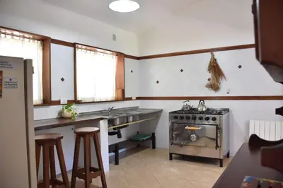a kitchen with a stove and a counter with stools at Chalet Tornasol in El Rincón