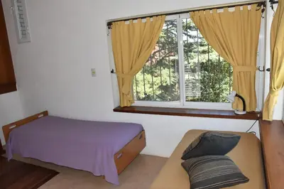 a bedroom with a bed and a window and a couch at Chalet Tornasol in El Rincón