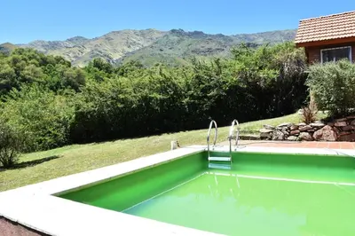 a swimming pool in a yard with mountains in the background at Chalet Tornasol in El Rincón