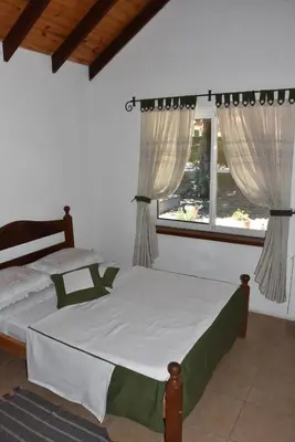 a bedroom with a bed and two windows at Chalet Tornasol in El Rincón