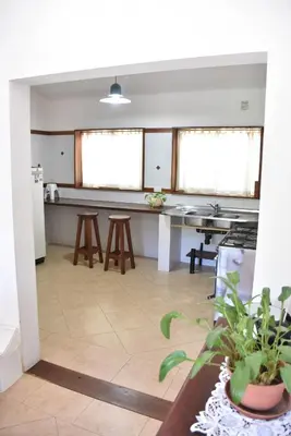 a kitchen with wooden stools and a counter top at Chalet Tornasol in El Rincón