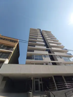a tall apartment building with the sky in the background at Edificio Leonardo, 5to piso in Villa Carlos Paz