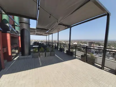 a balcony of a building with a view of the city at Edificio Leonardo, 5to piso in Villa Carlos Paz