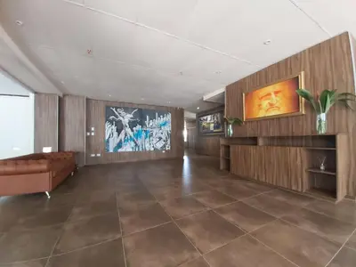 a living room with a couch and a television at Edificio Leonardo, 5to piso in Villa Carlos Paz
