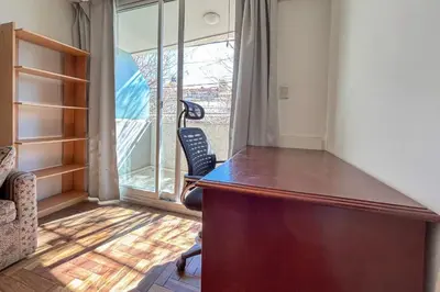 a desk with a chair in a room with a window at Apartamento Alta Córdoba con piscina! in Cordoba