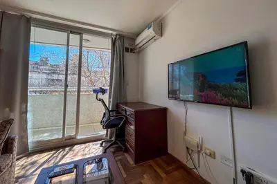 a living room with a flat screen tv on the wall at Apartamento Alta Córdoba con piscina! in Cordoba