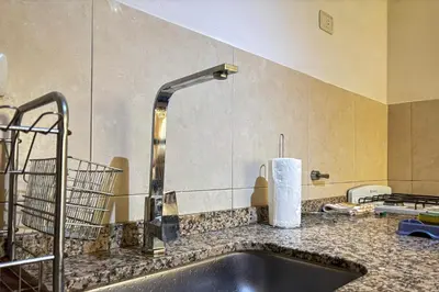 a kitchen with a sink and a faucet at Apartamento Alta Córdoba con piscina! in Cordoba