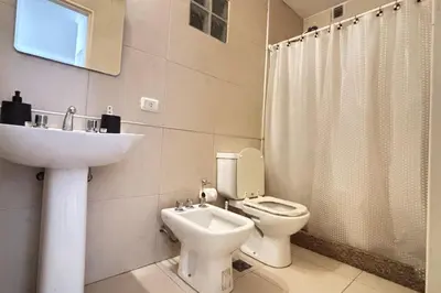 a bathroom with a toilet and a sink at Apartamento Alta Córdoba con piscina! in Cordoba