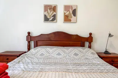 a bedroom with a bed with three pictures on the wall at Apartamento Alta Córdoba con piscina! in Cordoba