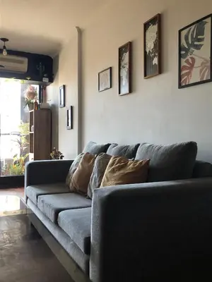 a living room with a gray couch with pillows on it at 