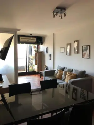 a living room with a couch and a glass table at 
