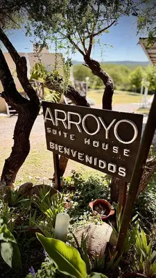 a sign for an entrance to an aroco suite house at ARROYO SUITE HOUSE in Mina Clavero