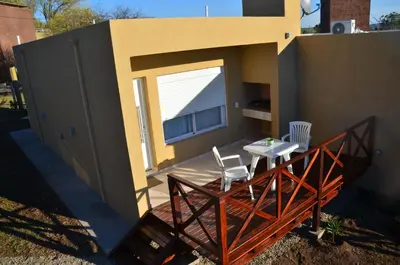 a patio with a table and chairs on a house at ARROYO SUITE HOUSE in Mina Clavero