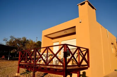 a small building with a wooden bridge in front of it at ARROYO SUITE HOUSE in Mina Clavero