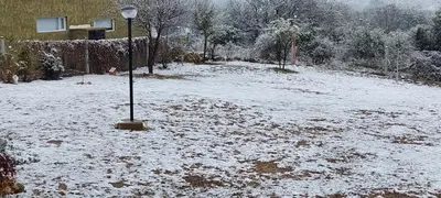 a snow covered yard with a light pole in it at ARROYO SUITE HOUSE in Mina Clavero