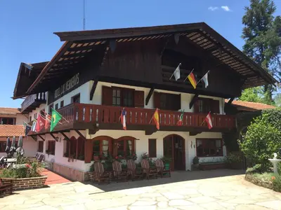 a building with flags on the front of it at Las Verbenas Hotel in La Cumbrecita