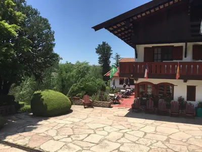 a building with a patio in front of it at Las Verbenas Hotel in La Cumbrecita