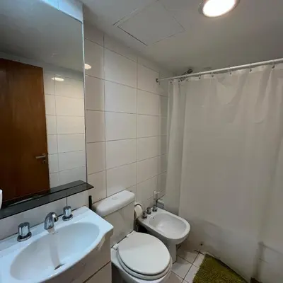 a bathroom with a toilet and a sink and a mirror at Jardines del Boulevard 2 in Cordoba