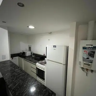 a kitchen with a white refrigerator and a stove at Jardines del Boulevard 2 in Cordoba