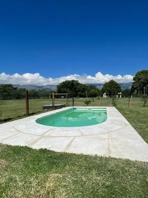 a small pool in the middle of a field at La Catalina Suites de Campo in Nono