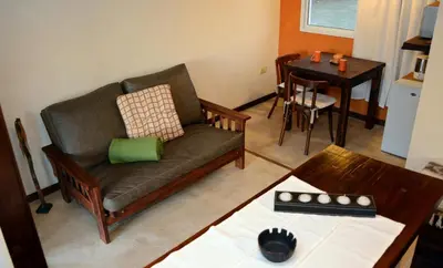 a living room with a couch and a table at La Catalina Suites de Campo in Nono