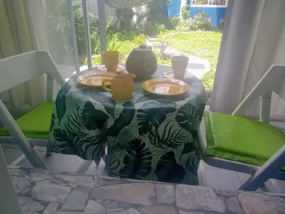 a table with a table cloth with plates and cups on it at RAIZ DEL CIELO, entre 2 jardines de ensueño in Cordoba