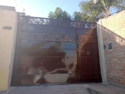 a garage door with a dog standing in it at RAIZ DEL CIELO, entre 2 jardines de ensueño in Cordoba