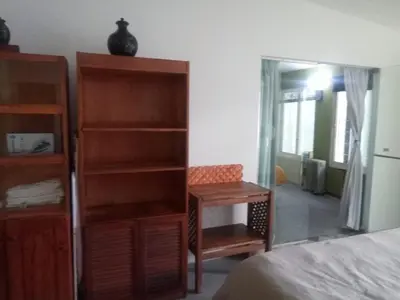 a bedroom with a book shelf next to a bed at RAIZ DEL CIELO, entre 2 jardines de ensueño in Cordoba
