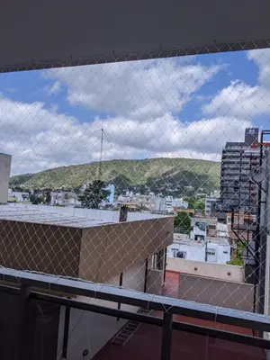 a view of a city through a chain link fence at DEPARTAMENTO Edificio LEONARDO in Villa Carlos Paz