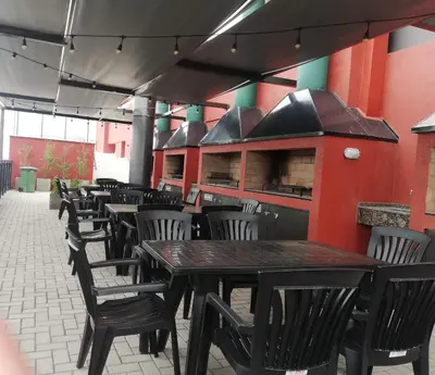 a row of tables and chairs in a restaurant at DEPARTAMENTO Edificio LEONARDO in Villa Carlos Paz
