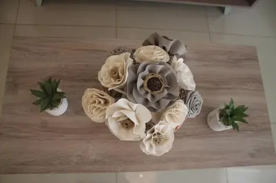 a cake with white flowers on top of a table at Dpto Downtown Nueva Córdoba, la mejor ubicación!! Sin Gastos adicionales - Cochera opcional in Cordoba