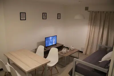 a living room with a desk with a computer and chairs at Dpto Downtown Nueva Córdoba, la mejor ubicación!! Sin Gastos adicionales - Cochera opcional in Cordoba