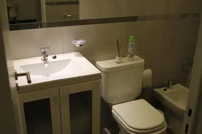 a bathroom with a white toilet and a sink at Dpto Downtown Nueva Córdoba, la mejor ubicación!! Sin Gastos adicionales - Cochera opcional in Cordoba