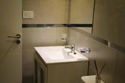a bathroom with a sink and a mirror at Dpto Downtown Nueva Córdoba, la mejor ubicación!! Sin Gastos adicionales - Cochera opcional in Cordoba