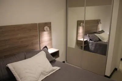 a bedroom with a mirror and a bed in a room at Dpto Downtown Nueva Córdoba, la mejor ubicación!! Sin Gastos adicionales - Cochera opcional in Cordoba