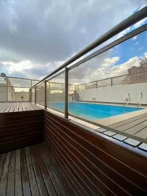 a balcony with a view of a swimming pool at Calidez in Villa Carlos Paz