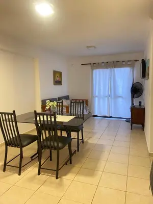 a dining room with a table and four chairs at Calidez in Villa Carlos Paz
