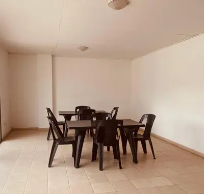 a dining room with black tables and chairs at Calidez in Villa Carlos Paz