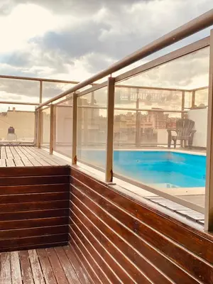 a balcony with a view of a swimming pool at Calidez in Villa Carlos Paz