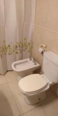 a bathroom with a toilet and a bidet at Calidez in Villa Carlos Paz