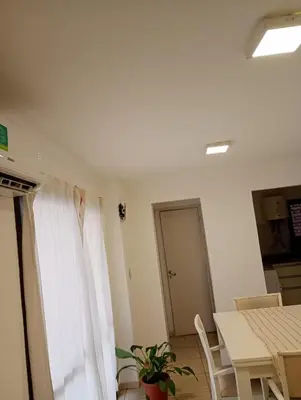 a room with a table and a white curtain at Apart salguero in Cordoba