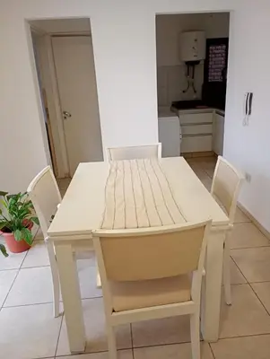 a white table and chairs in a kitchen at Apart salguero in Cordoba