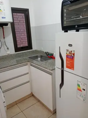 a kitchen with a refrigerator and a sink at Apart salguero in Cordoba