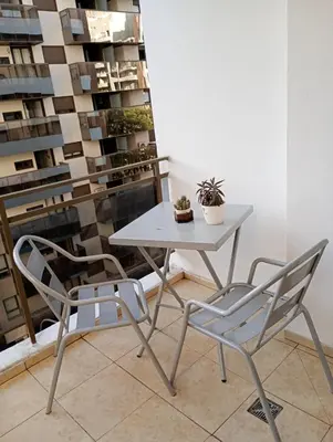 a white table and two chairs in a room at Apart salguero in Cordoba