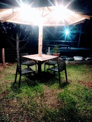 a table with two chairs under an umbrella at Terra Nostra in Cordoba