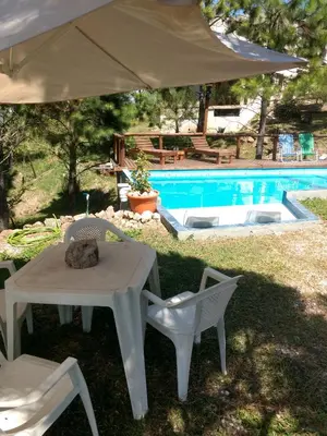 a cat sleeping on a table next to a pool at Terra Nostra in Cordoba