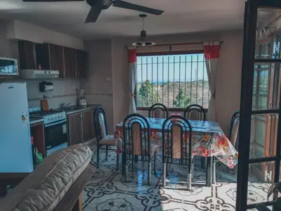 a kitchen and dining room with a table and chairs at Terra Nostra in Cordoba